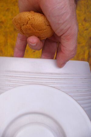hand caught stealing from cookie jar concept imageの写真素材