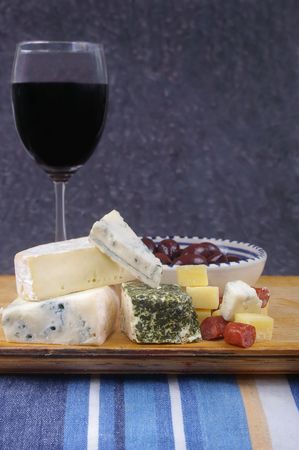 cheese antipasto varieties with olives and wineの写真素材