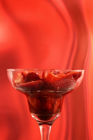 strawberry in cocktail glass with syrup of chocolate or vinegarの写真素材