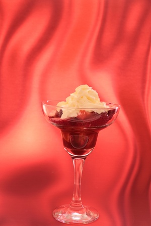 strawberry in cocktail glass with syrup of chocolate or vinegar and creamの写真素材