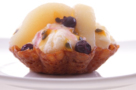 brown brandy snap ice cream basket with fruitの写真素材