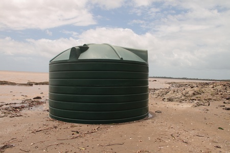 BRISBANE, AUSTRALIA - JAN 15 : Flood  and storm debris on Brisbane beach full water tank washed up January 15, 2011 in Brisbane, Australia のeditorial素材