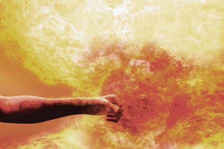 man punching through an explosion of plasma gas fire ballの写真素材