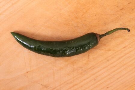 green sweet and hot small chilli on boardの写真素材
