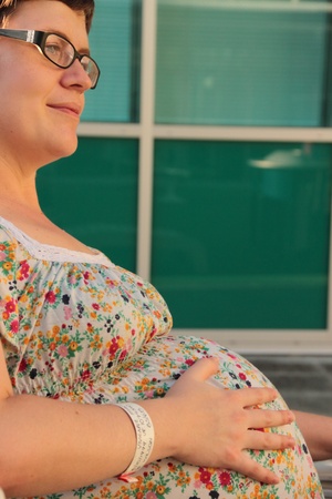 pregnant woman experiencing braxton hicks contractions in third trimester with twin on grounds of rbhの写真素材