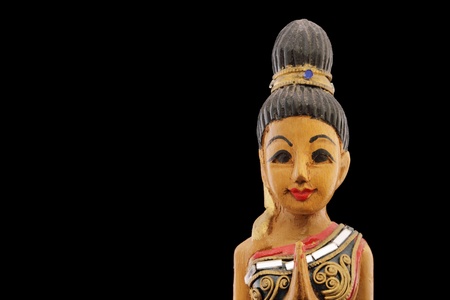thailand wooden Souvenir woman in traditonal prayer and thanking pose isolatedの写真素材