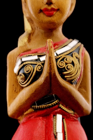thailand wooden Souvenir woman in traditonal prayer and thanking pose isolatedの写真素材