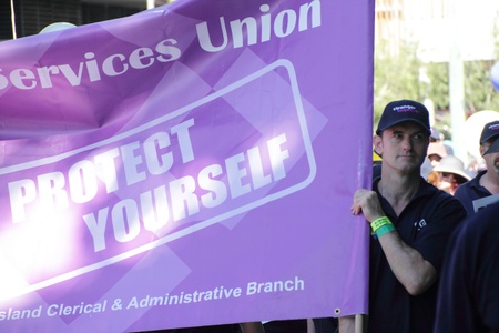 BRISBANE, AUSTRALIA - MAY 2 : man carrying march banner for the services union during labour day march  May 2, 2011 in Brisbane, Australia のeditorial素材