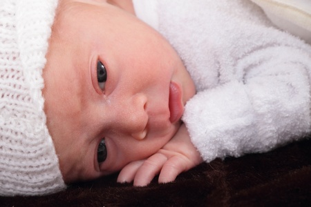 newborn infant baby on fur baby rug having nap timeの写真素材