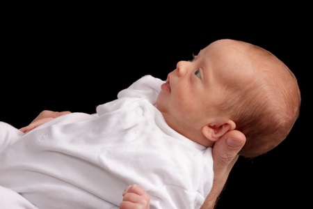 small premature baby girl being held for an isolated portraitの写真素材