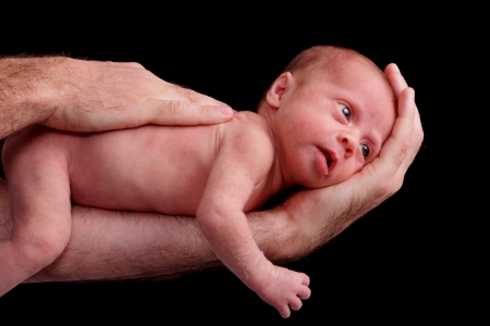 small premature baby girl being held for an isolated portraitの写真素材