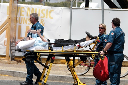 BRISBANE, AUSTRALIA  OCT 24 : Woman given medical attention in the heat during the English Royal visit October  24, 2011 in Brisbane, Australia のeditorial素材