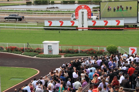 BRISBANE, AUSTRALIA  NOV 01 : Crowds trackside watching the big TV Eagle Farm Racourse as part of Melbourne Cup festival events November 01, 2011 in Brisbane, Australia のeditorial素材