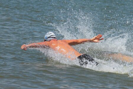 BRISBANE, AUSTRALIA  NOV 27 :Elite male swimmer butterflying out in dash for cash in Great Australian Swim Series race November 27, 2011 in Brisbane, Australia のeditorial素材