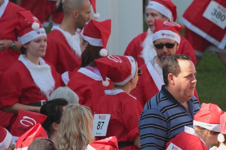 BRISBANE, AUSTRALIA  NOV 27 :Spectator mixes with unidentified group pre Variety Santa Fun Run November 27, 2011 in Brisbane, Australia のeditorial素材