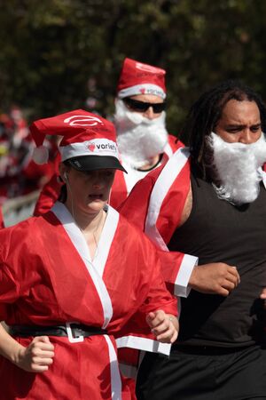 BRISBANE, AUSTRALIA  NOV 27 :Unidentified female and aboriginal santa side by side in Variety Santa Fun Run November 27, 2011 in Brisbane, Australia のeditorial素材