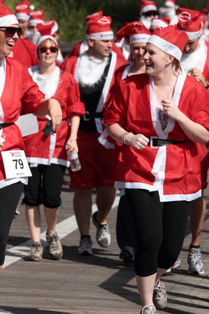 BRISBANE, AUSTRALIA  NOV 27 :Unidentified women santas sharing laugh in Variety Santa Fun Run November 27, 2011 in Brisbane, Australia のeditorial素材
