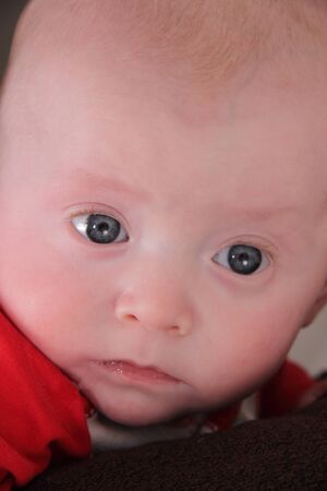 baby twin boy with a large 97th percentile expressive faceの写真素材
