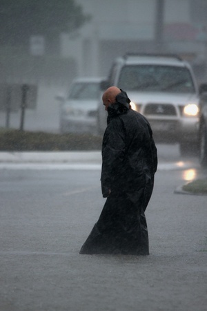 BRISBANE, AUSTRALIA - JANUARY 27 : Unidentified man braves the elements during ex tropical cyclone Oswald on January 27, 2013 in Brisbane, Australiaのeditorial素材