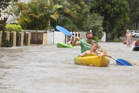 BRISBANE, AUSTRALIA - JANUARY 28 : Unidentified residents taking canoe rides in flooded street from ex tropical cyclone Oswald on January 28, 2013 in Brisbane, Australiaのeditorial素材