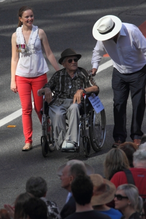 BRISBANE, AUSTRALIA - APRIL 25 : 104 yr old veteran Ken Blake pushed in wheelchair during along march route during Anzac day commemorations  April 25, 2013 in Brisbane, Australiaのeditorial素材
