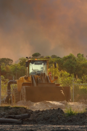 NINGI, AUSTRALIA - NOVEMBER 9   Mining frontend loader with backdrop of approaching bushfire...