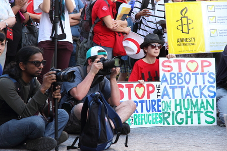 BRISBANE, AUSTRALIA - JUNE 22 : Unidentified protester holding anti goneverment immigration policy sign whilst attending World Refugee Rally June 22, 2014 in Brisbane, Australiaのeditorial素材