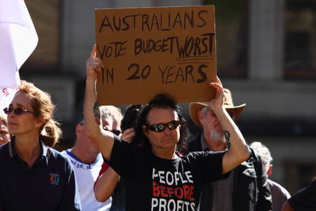 BRISBANE, AUSTRALIA - JULY 06 : Unidentified protester anti budget with sign at Bust The Budget anti liberal governement Rally July 06, 2014 in Brisbane, Australiaのeditorial素材