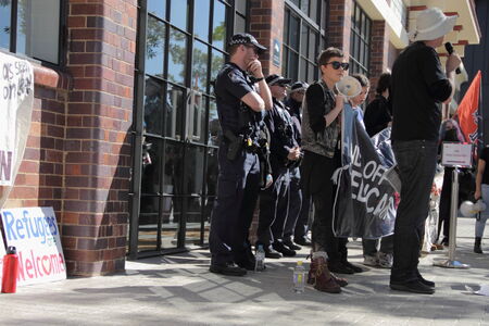 BRISBANE, AUSTRALIA - JULY 12 : Unidentified protesters in front of police cordon outside Liberal National Party national conerfence July 12, 2014 in Brisbane, Australiaのeditorial素材