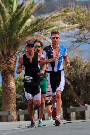 MOOLOOLABA, AUSTRALIA - SEPTEMBER 14 : Pros Dan Wilson (green), Brad Kahlefeldt (blue) , Courtney Atkinson (black) in the "Ironman 70.3" triathlon on September 14, 2014 in Mooloolaba, Australiaのeditorial素材