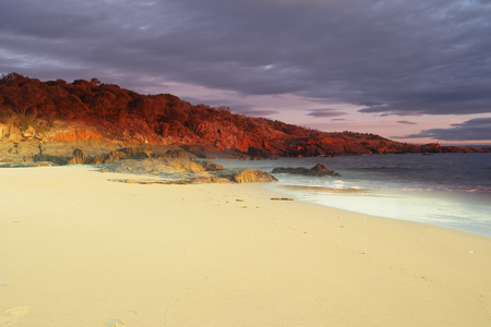Spiky beach swansea tasmania with famous red lichen rocksの写真素材