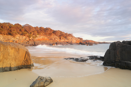 Spiky beach swansea tasmania with famous red lichen rocksの写真素材