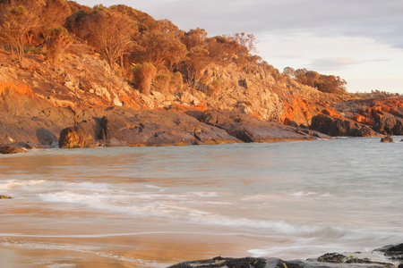 Spiky beach swansea tasmania with famous red lichen rocksの写真素材