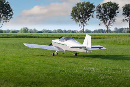Light plane ready to take off on a grassy airport.の写真素材