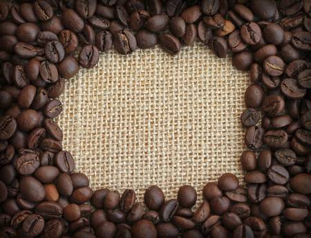 Frame of coffee beans on canvas background, close-upの写真素材