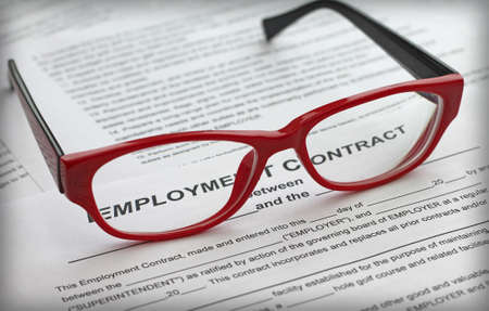 employment contract and female red glasses, close-upの写真素材