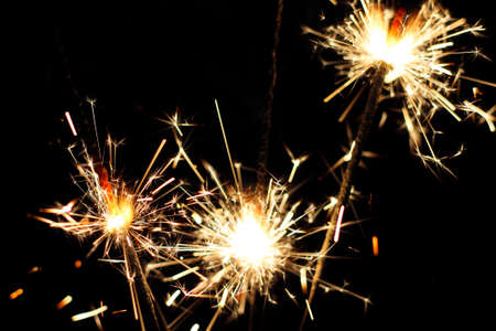 three burning sparklers, close-up