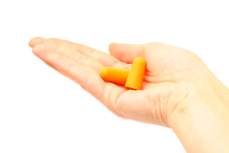 Woman's hand holding earplugs isolated on white, close-up