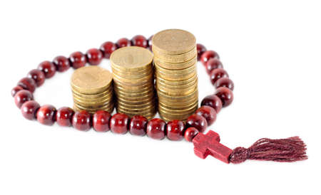 Idea of religion as successful business - rosary with coinsの写真素材