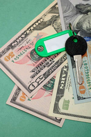 Key from rented apartment with dollars. Concept of rental housingの写真素材