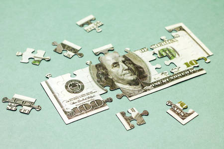 Business concept. Image of dollar like puzzle on green backgroundの写真素材