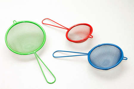Set of colorful kitchen strainers, on light backgroundの写真素材
