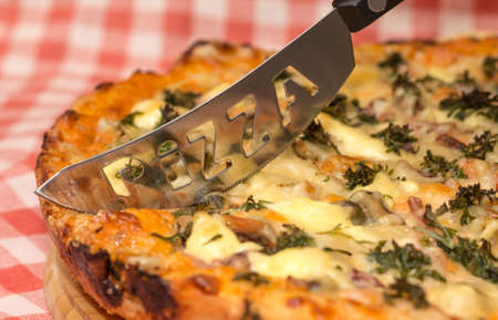 Image of appetizing homemade pizza and original knife
