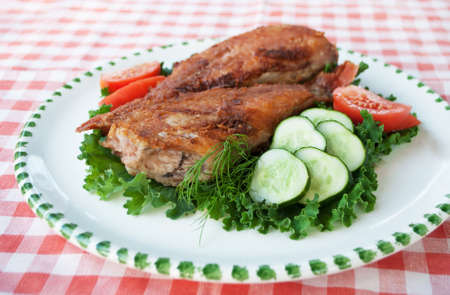 Healthy food. Fried sea bass on plate with vegetablesの写真素材