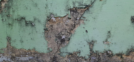 Old wall with peeling green paint. Background and texture for design.