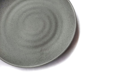 Empty circle grey ceramic plate isolated on white background. Clipping path included.