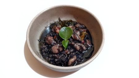 Squid Black Ink Soup or Tumis Cumi Tinta Hitam Served on Bowl. Indonesian Traditional Food