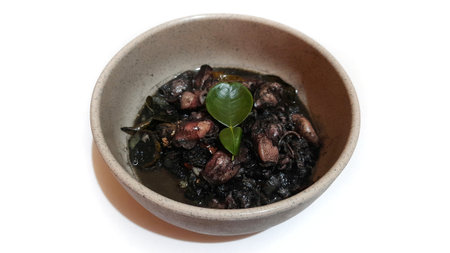 Squid Black Ink Soup or Tumis Cumi Tinta Hitam Served on Bowl. Indonesian Traditional Food