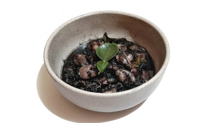 Squid Black Ink Soup or Tumis Cumi Tinta Hitam Served on Bowl. Indonesian Traditional Food