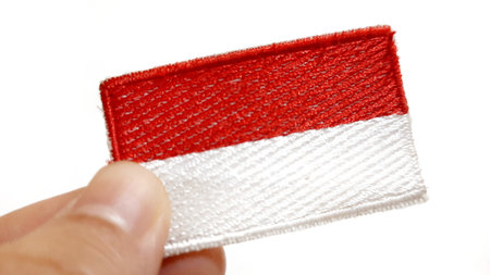 Hand Holding an Indonesian Flag Patch. Happy Anniversary Independence Day of Indonesia, August 17Th...